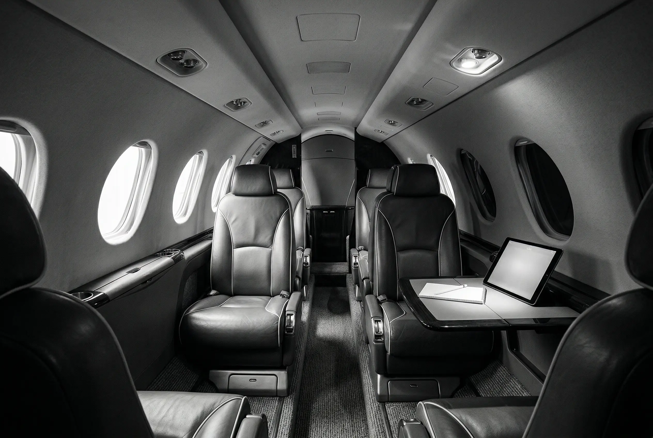 Citation CJ3+ cabin interior with leather club seating and natural light from large windows