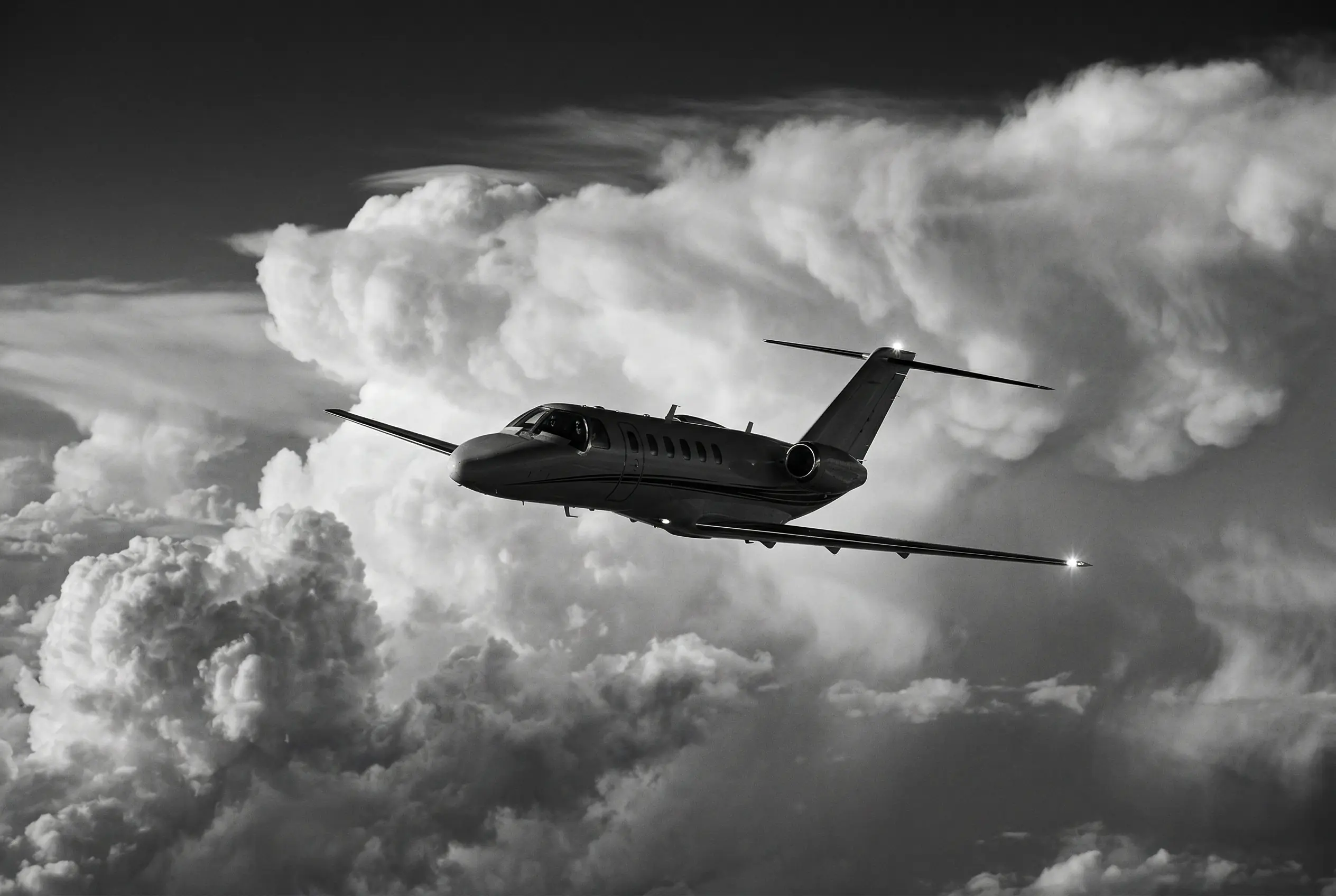 Citation CJ3+ cabin interior with leather seating and large oval windows flooding the cabin with natural light